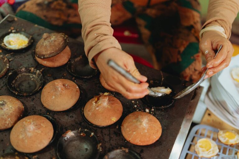 Capturing the intricate process of making Vietnamese street snacks using clay molds.